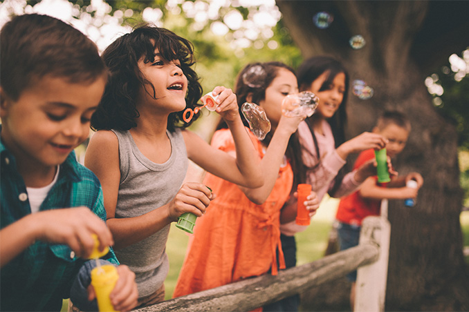 children blowing bubbles