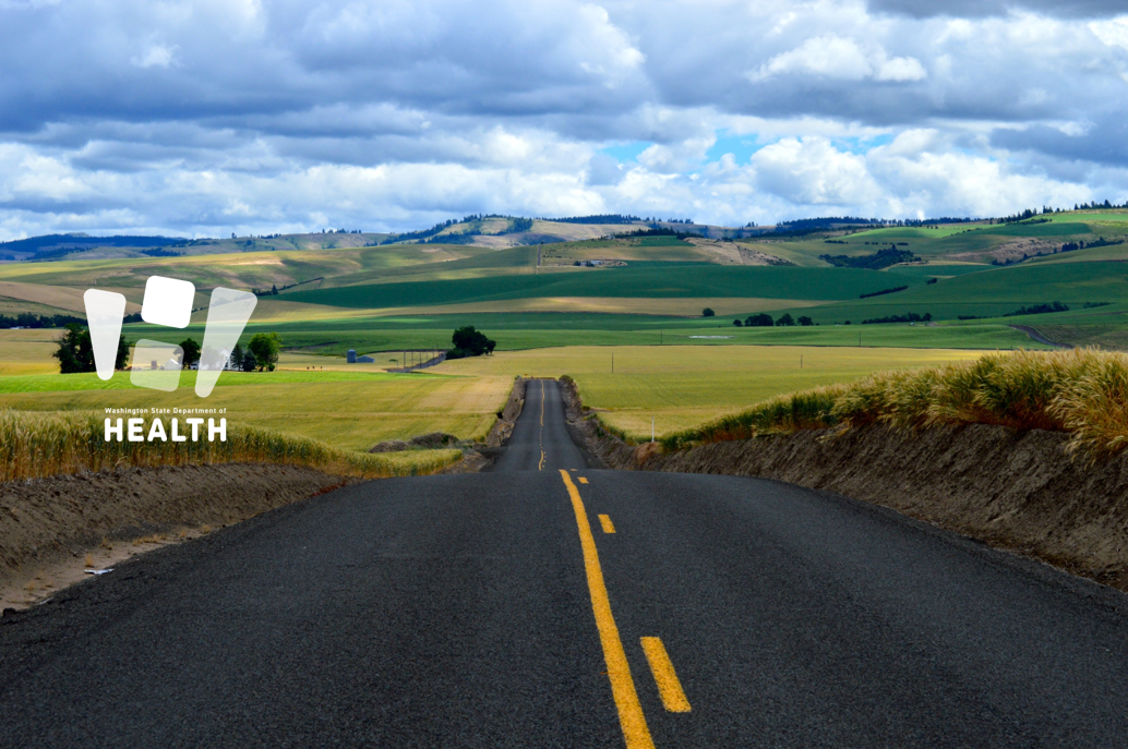 Landscape image of a road in a rural area.
