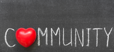 Chalkboard background with community written in chalk and the "o" replaced with a red heart